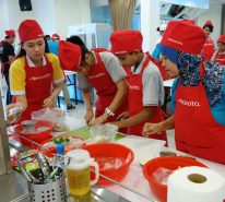 Ajinomoto staff and the children struggle in the cooking competition that required preparing 2 main recipes.
